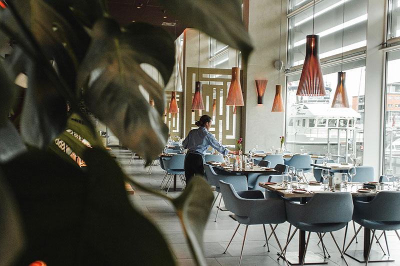 Situated next to a pier, this restaurant uses light blue tones in their waitress uniforms.